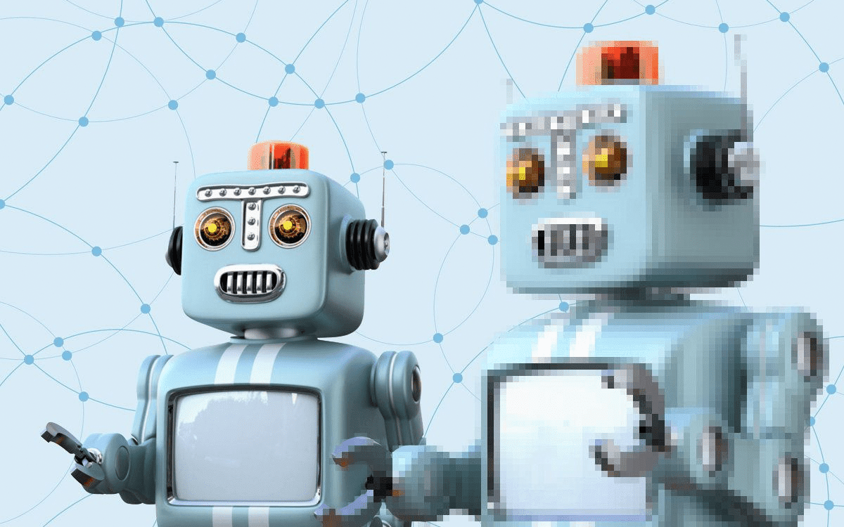 Two blue toy robots, one in focus, the other slightly pixelated