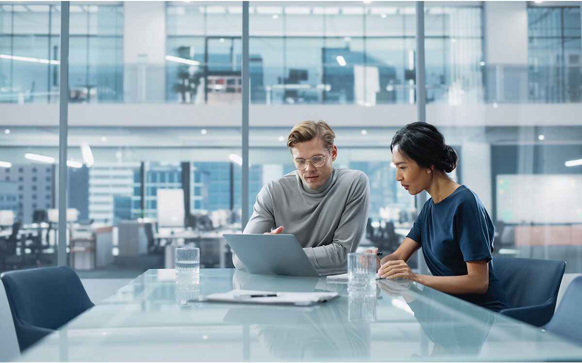 Multiethnic Diverse Office Conference Room Meeting: Team of Two Creative Entrepreneurs Talk, Discuss Growth Strategy. Stylish Young Businesspeople work on Investment and Marketing Projects.