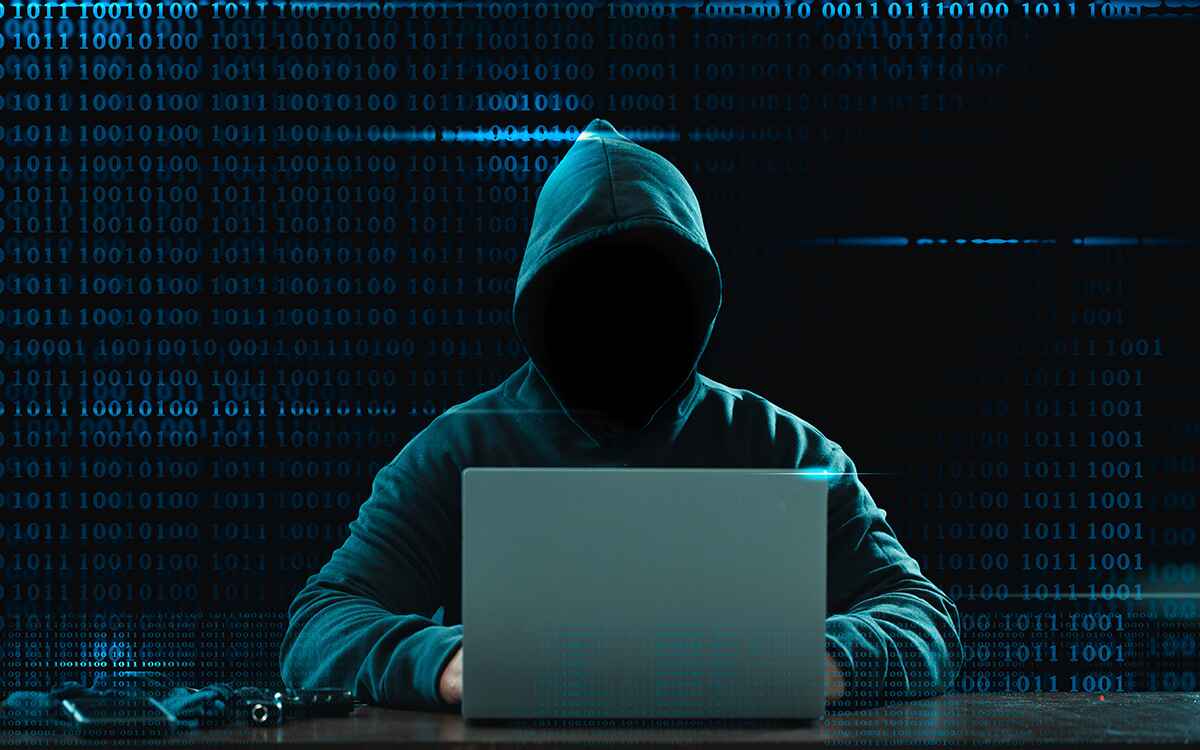 Big financial data theft concept. An anonymous hacker is hacking highly-protected financial data through computers.