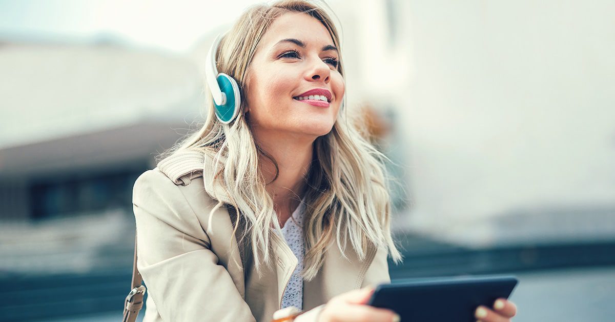 A woman listening to music on a streaming service and playing an online game