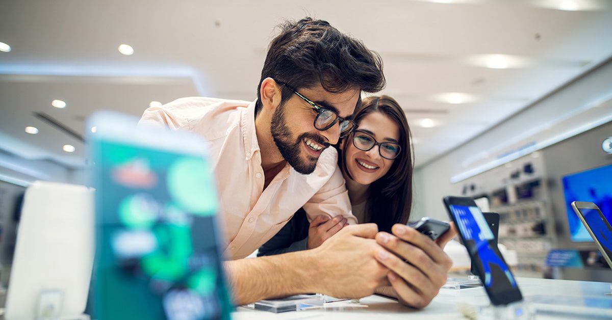 Woman and man buying mobile phones from a large Internet company