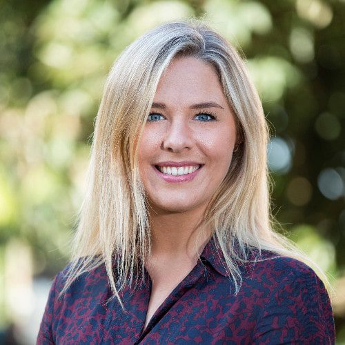 Blonde woman looking towards camera