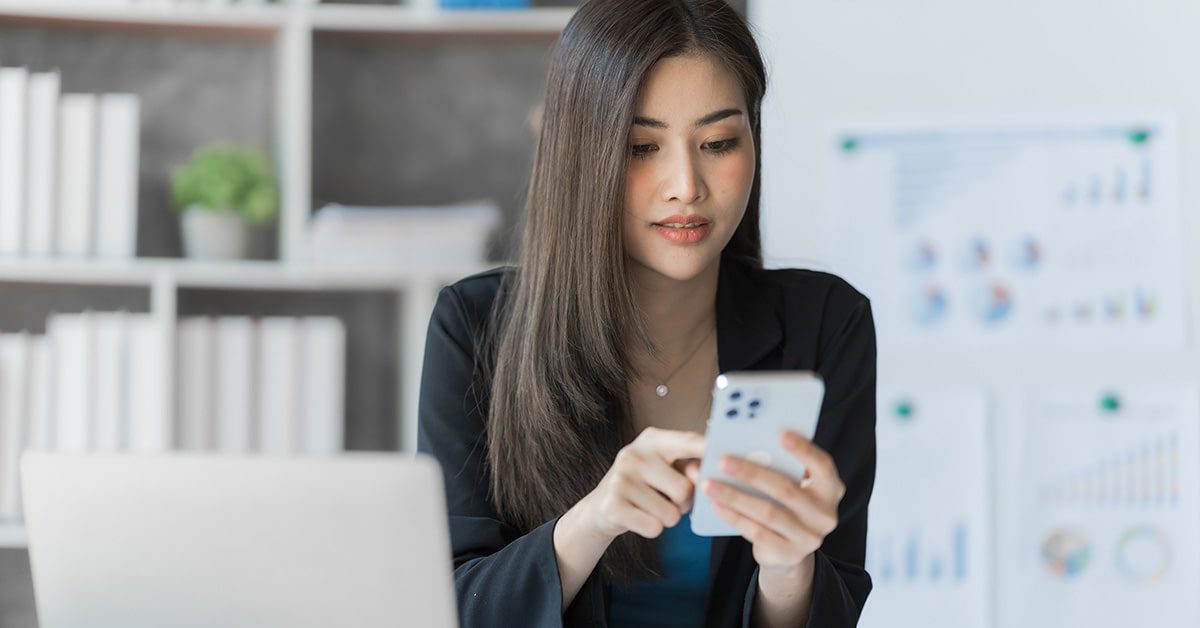 A woman looking at her online account on her mobile phone