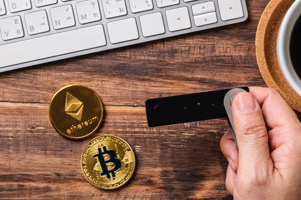 nft-bot-hand-holding-hardware-wallet-and-transfer-bitcoin