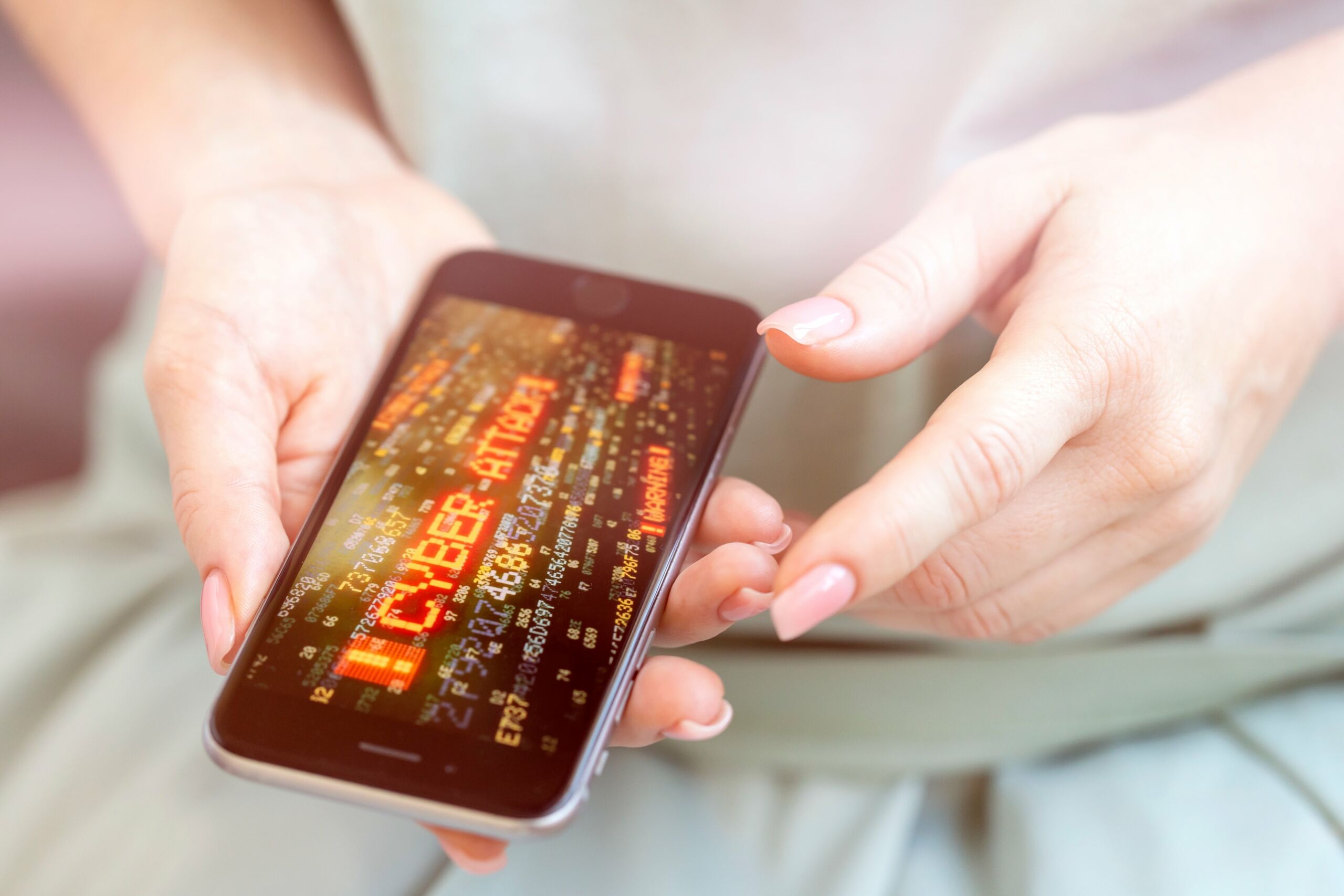 cyber attack on mobile phone in womens hands
