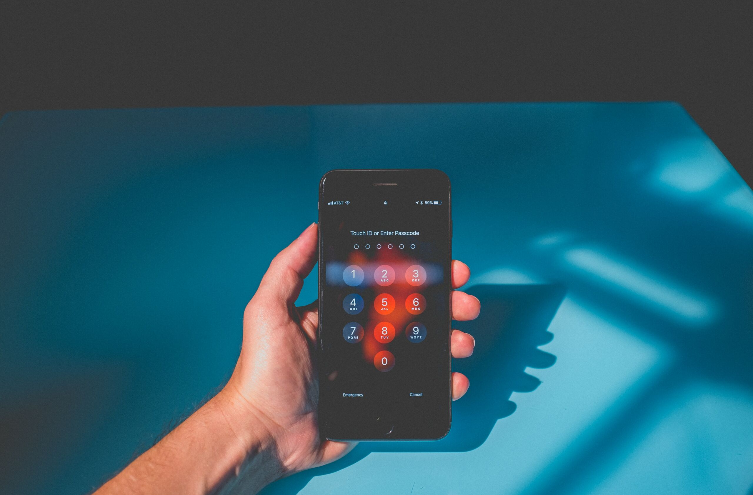 hand holding iphone password screen