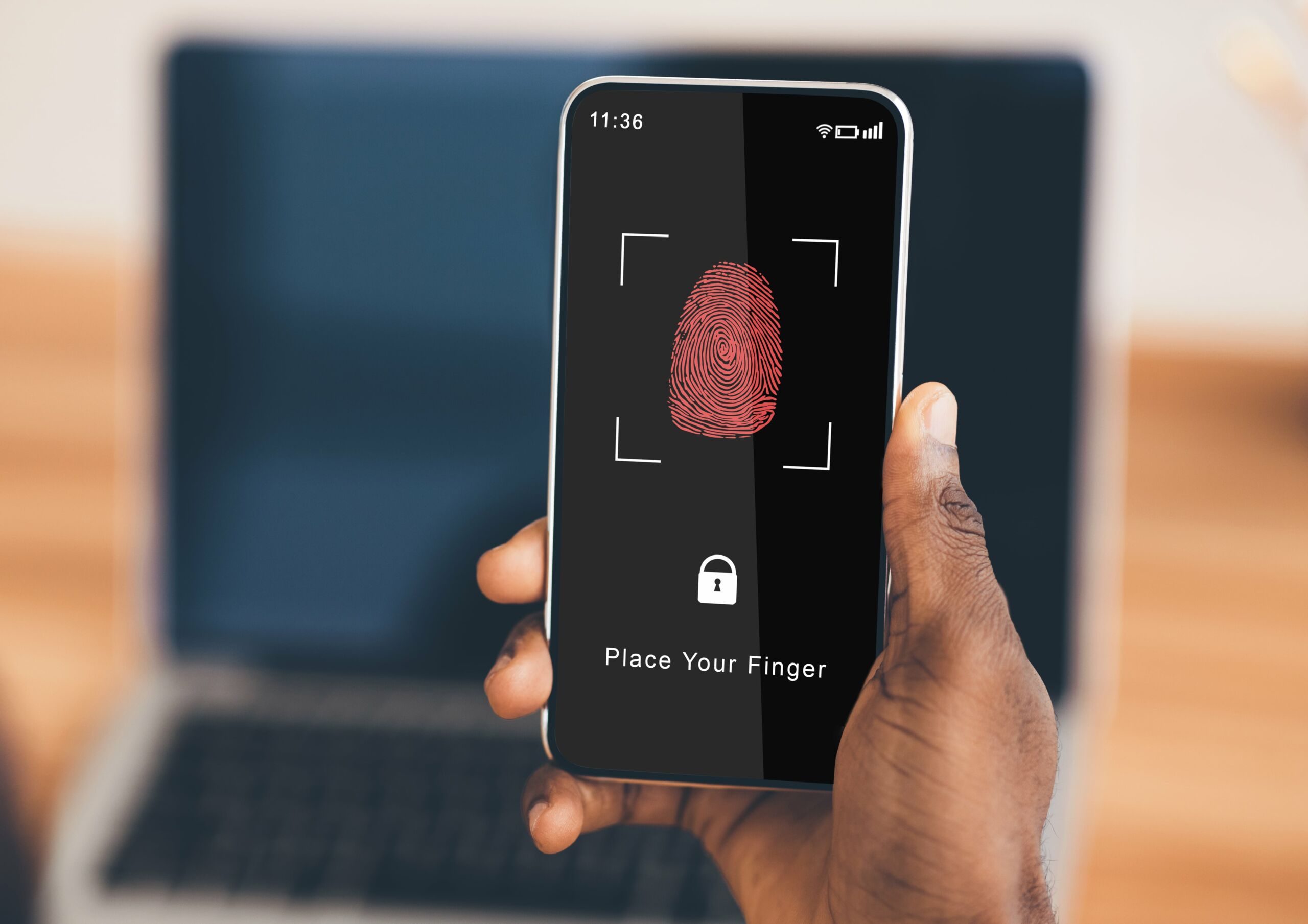 person holding phone with fingerprint scanning 