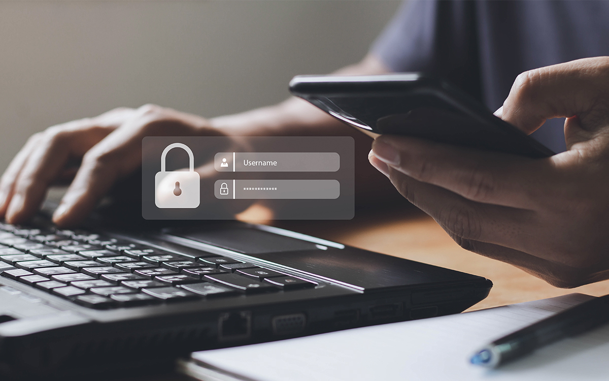 A person using a laptop to access a secure account, illustrating security measures to prevent toll fraud