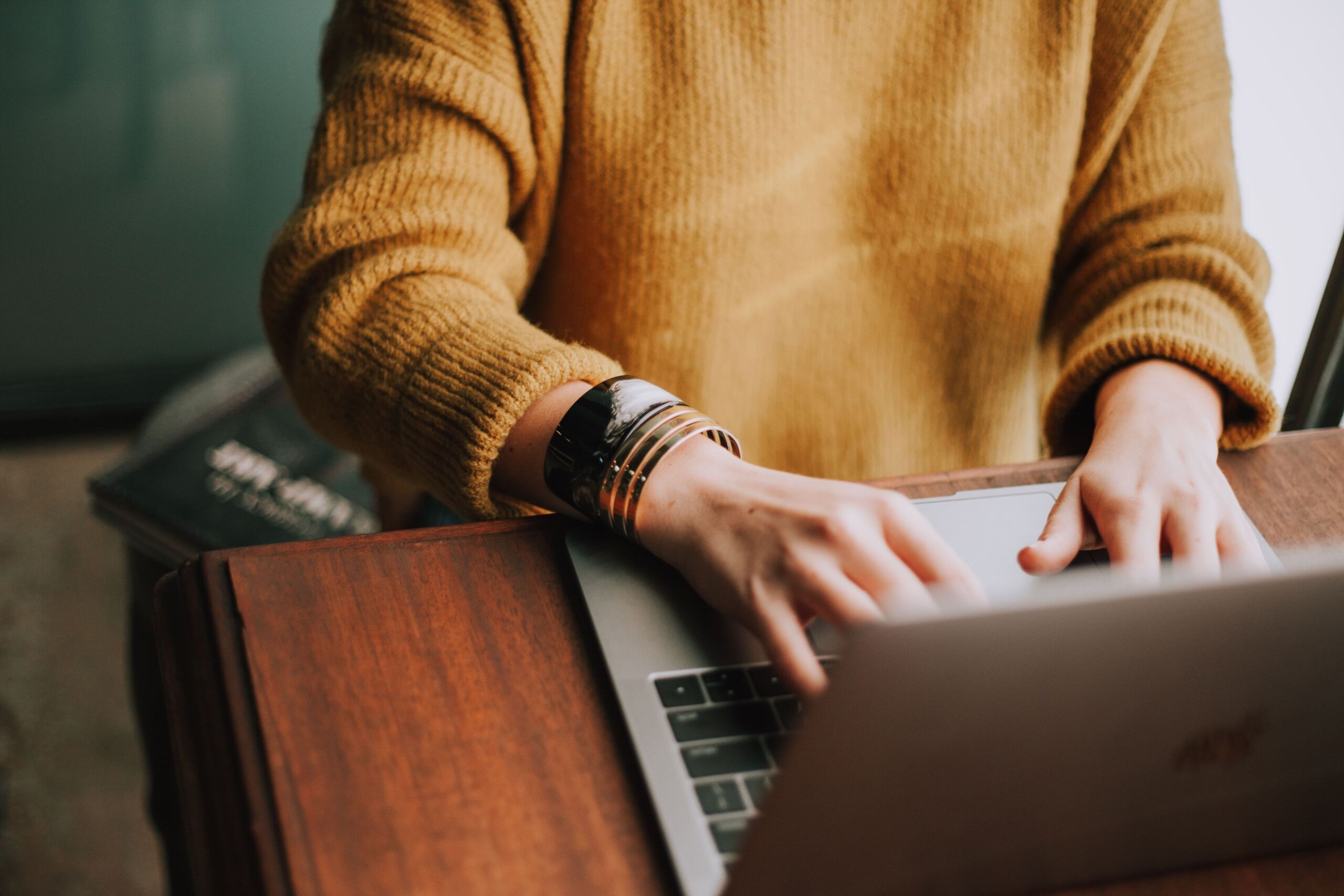 person typing on laptop at desk 