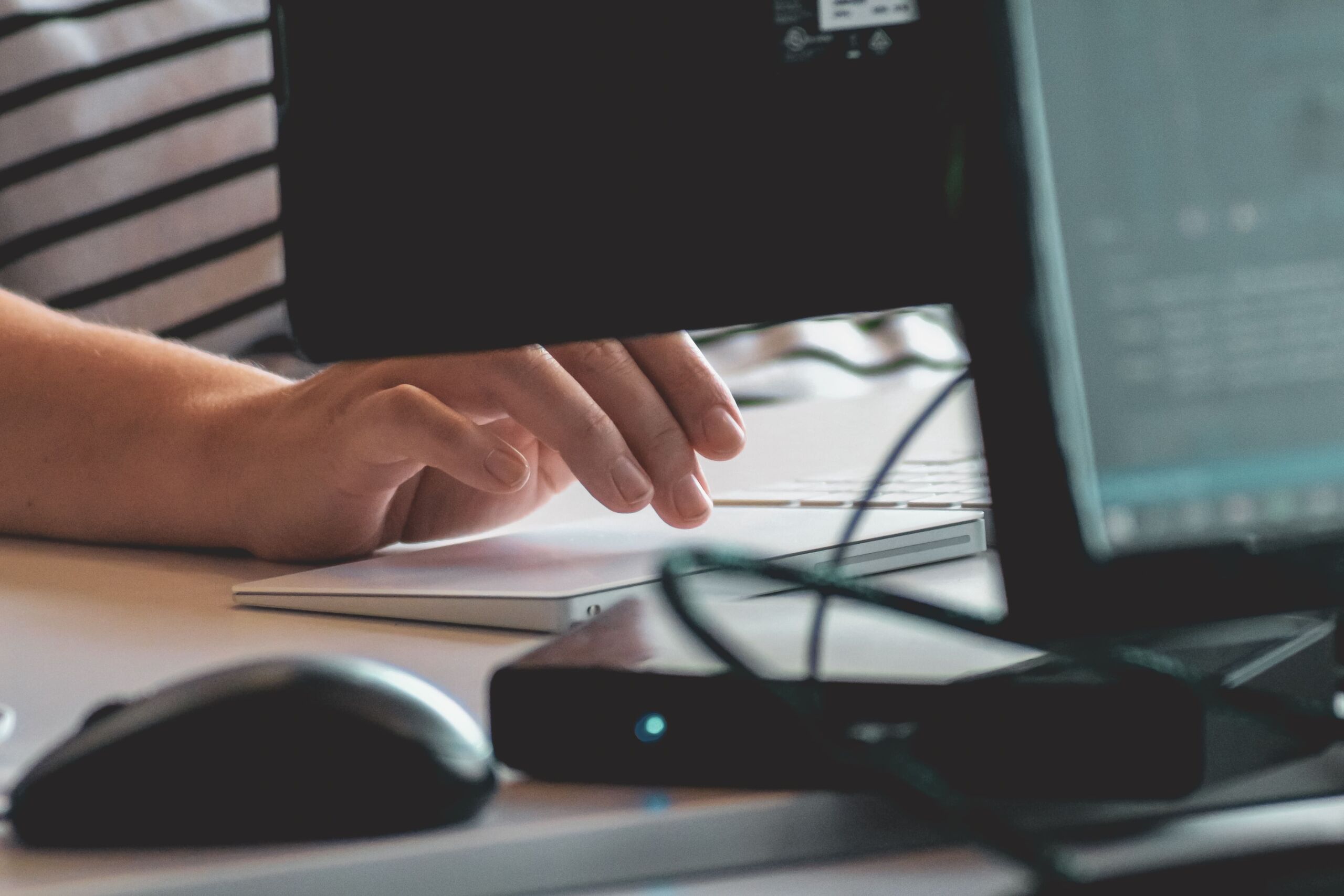 persons hand using computer