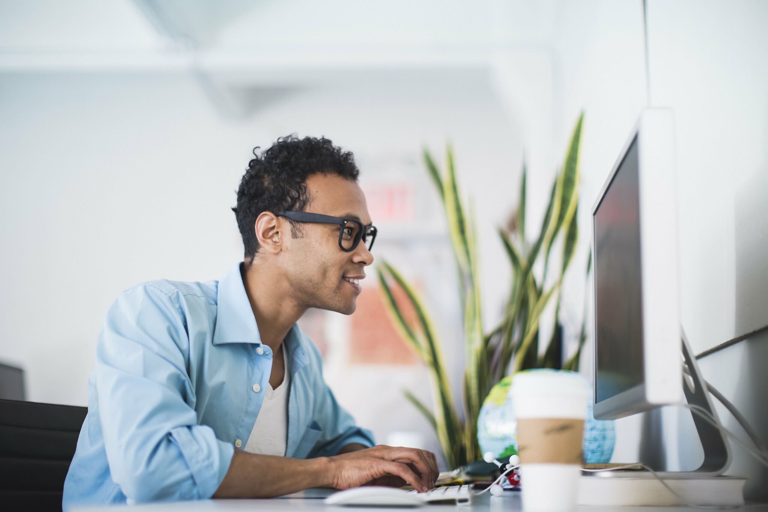 young man working at computer at office