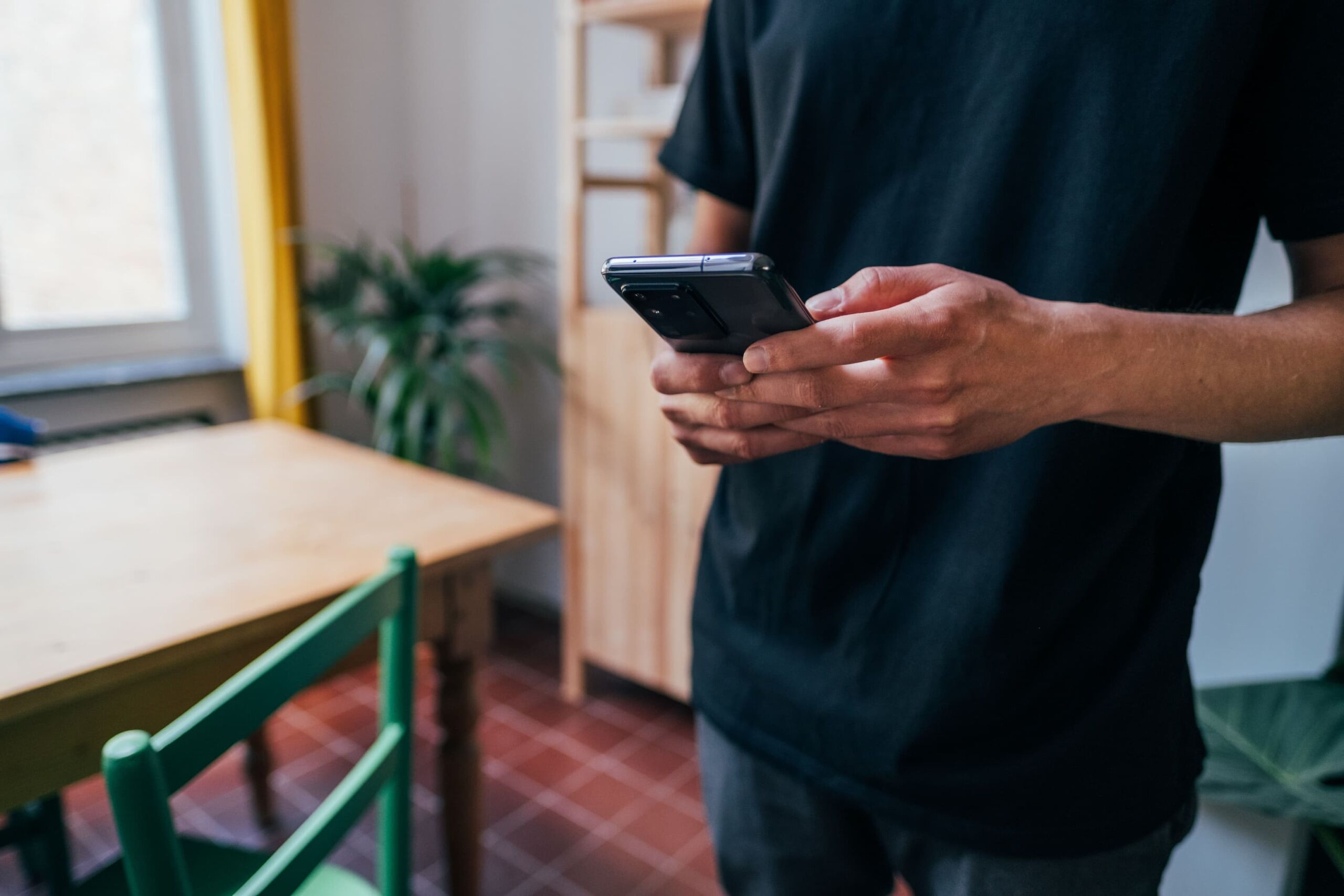 person-using black iphone 