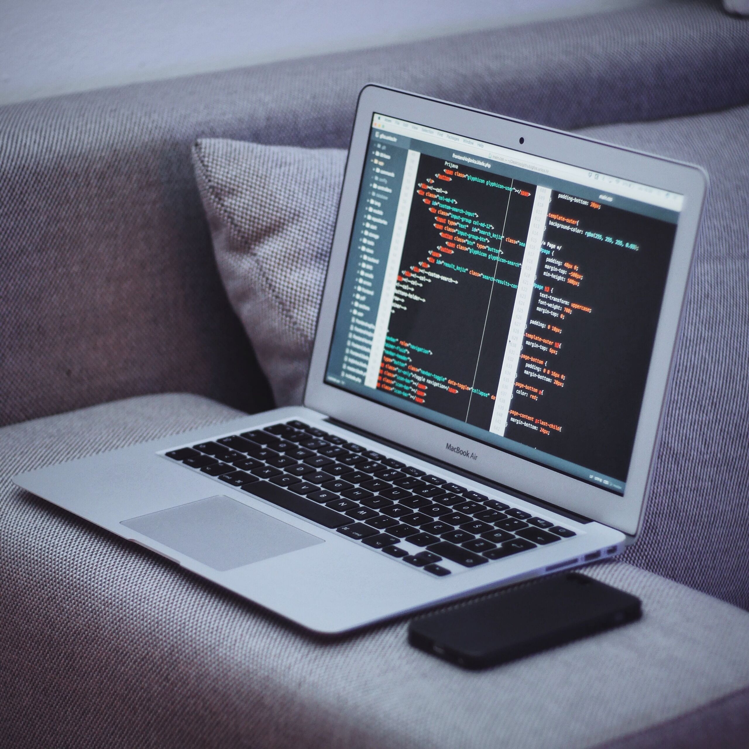 code on laptop on couch 