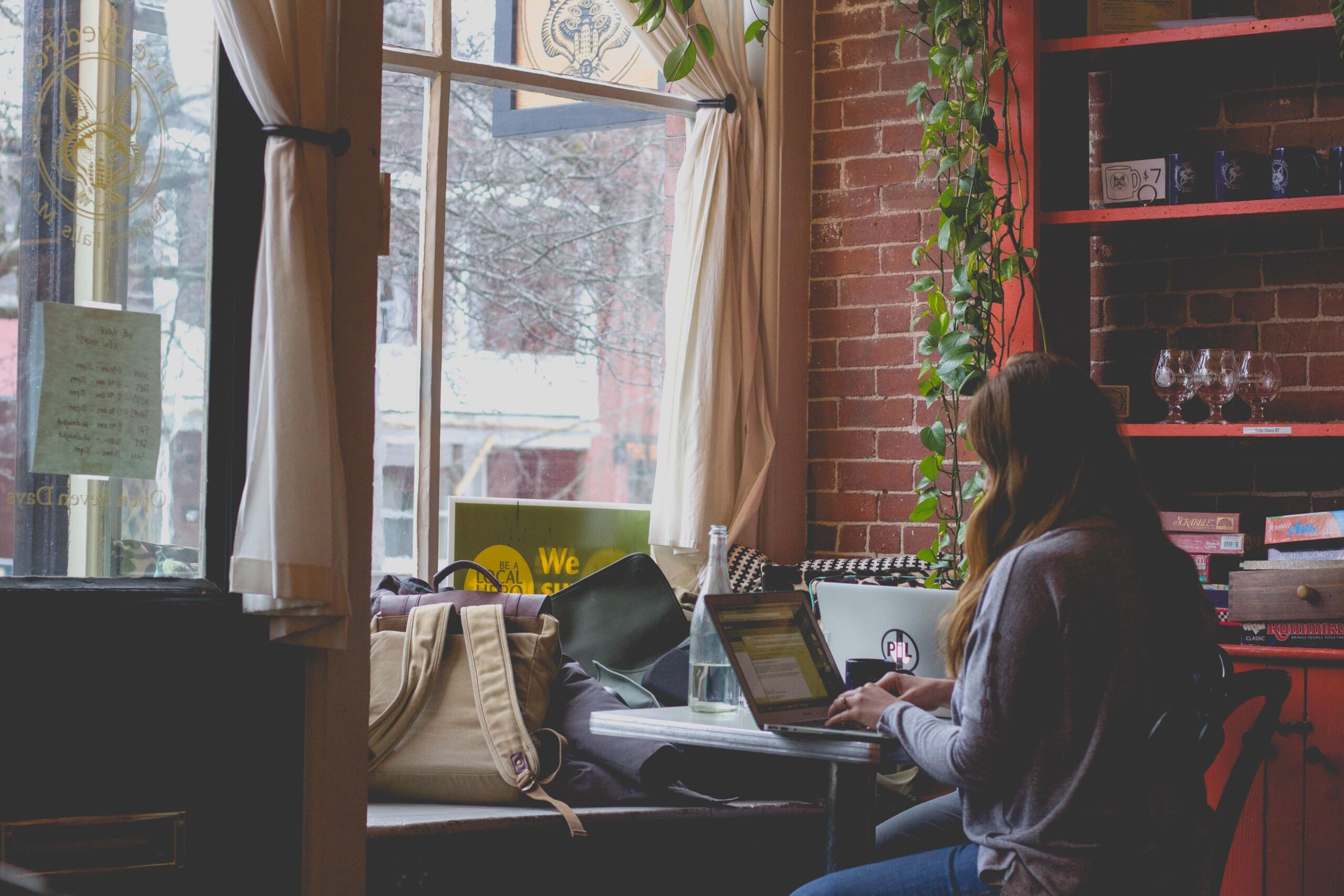person in coffee shop on laptop 