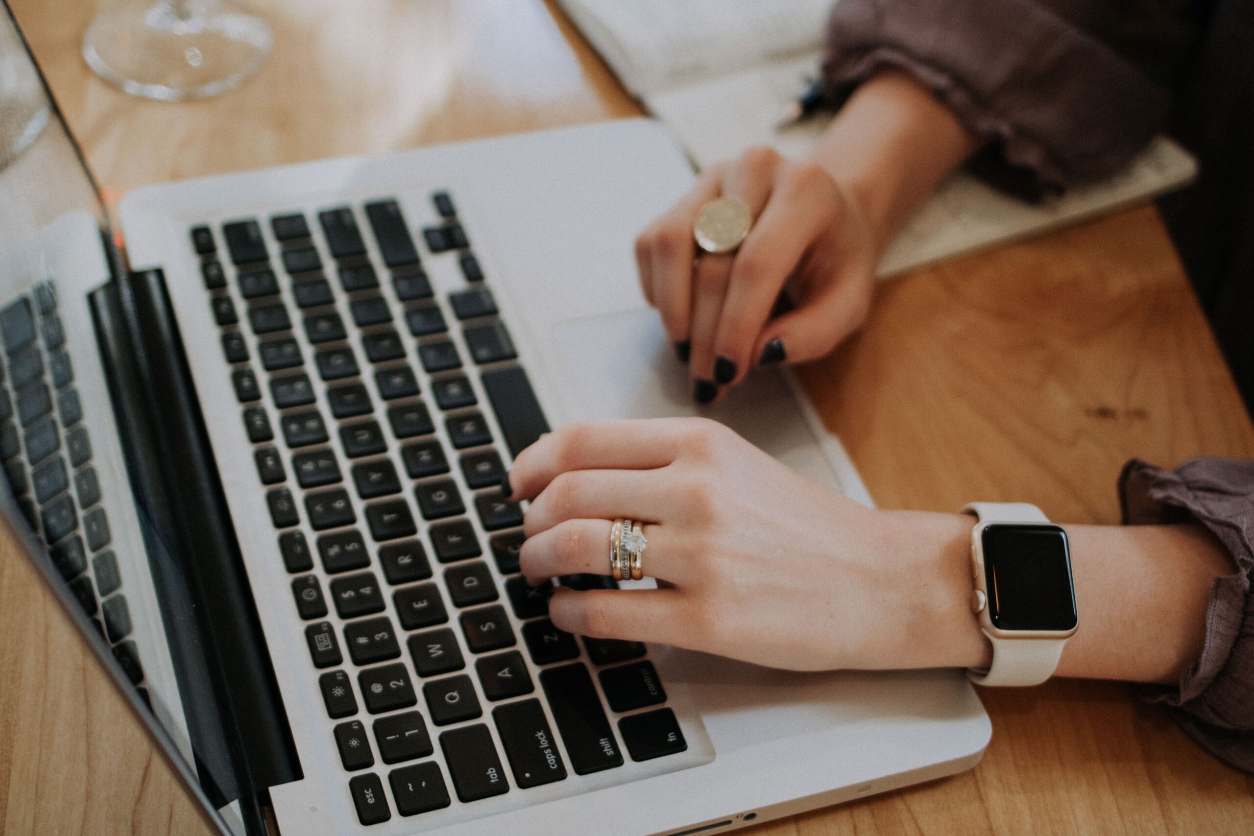 person hand typing on laptop