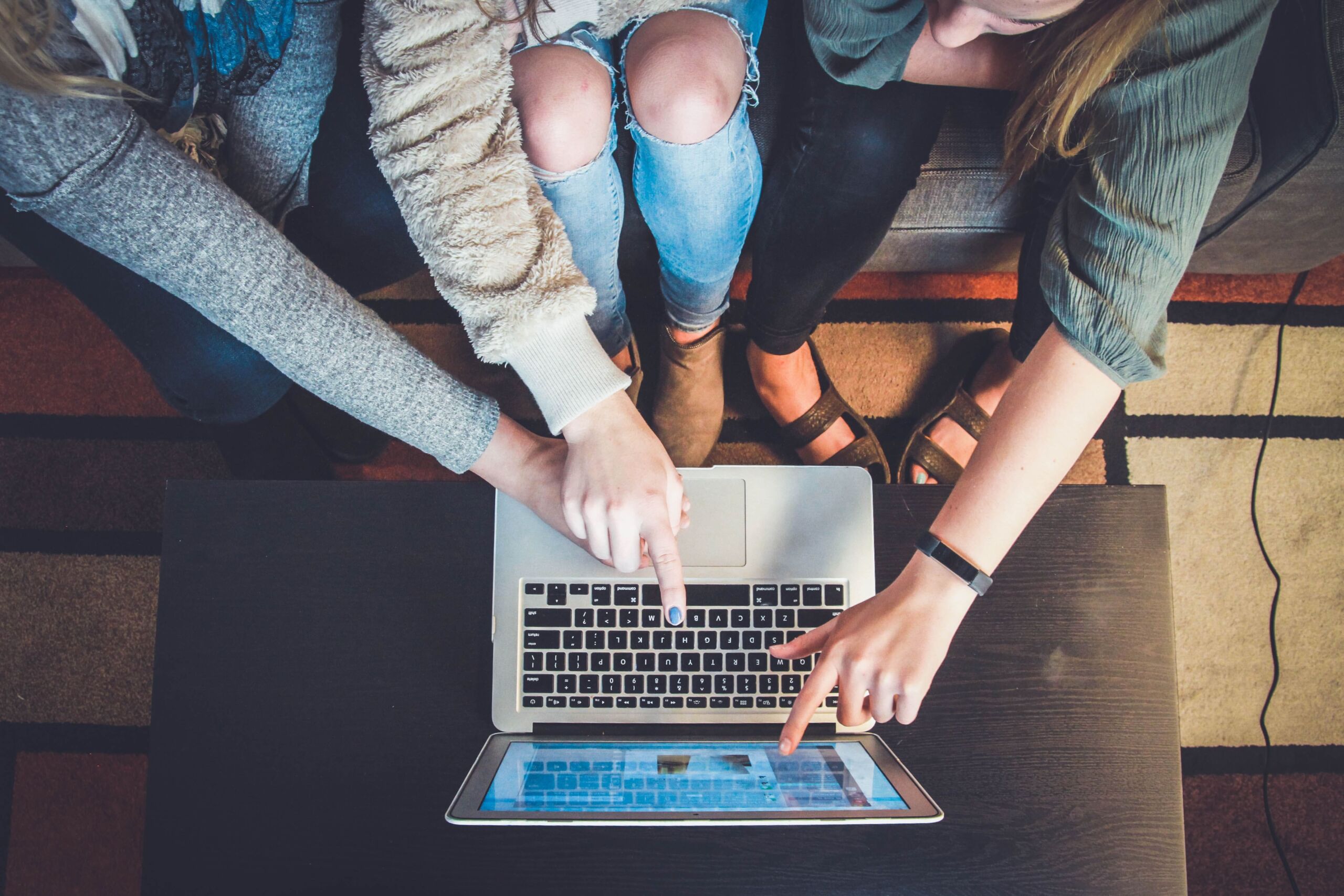 users at laptop pointing to screen