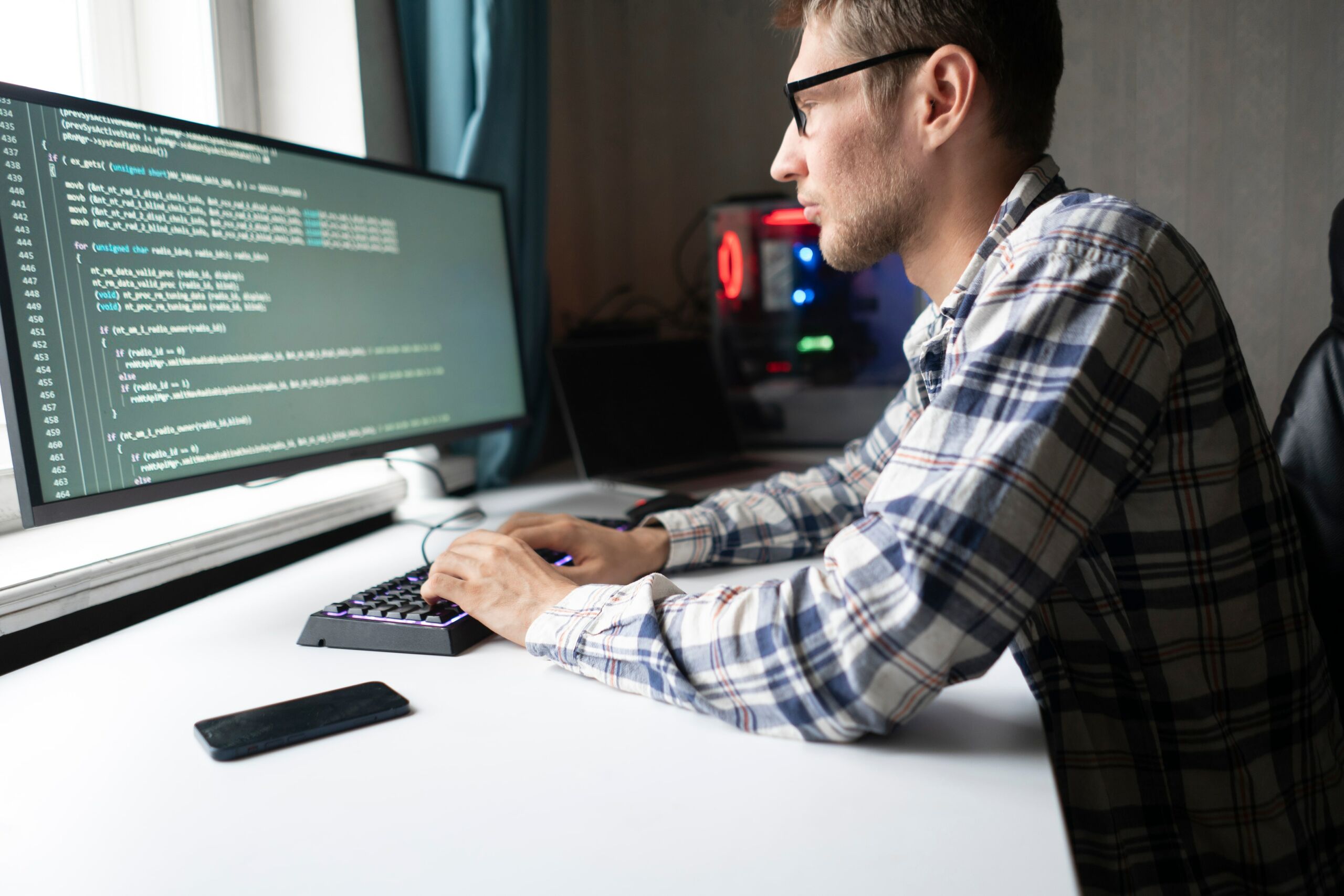 A man sitting at a desk with a computer screen in front of him, engaged in CAPTCHA verification.