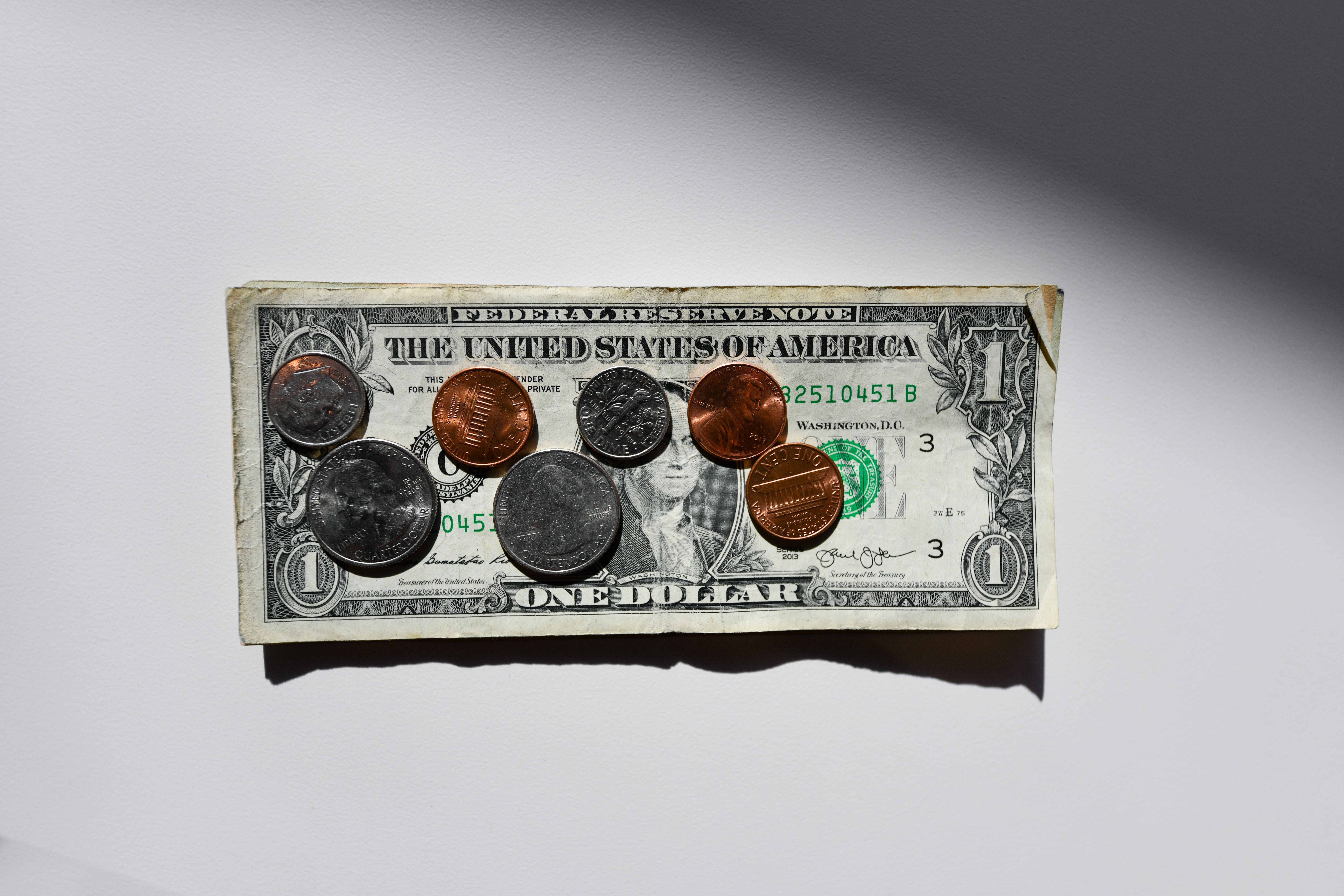  A dollar bill decorated with pennies and quarters, showcasing an attractive design of various coins.