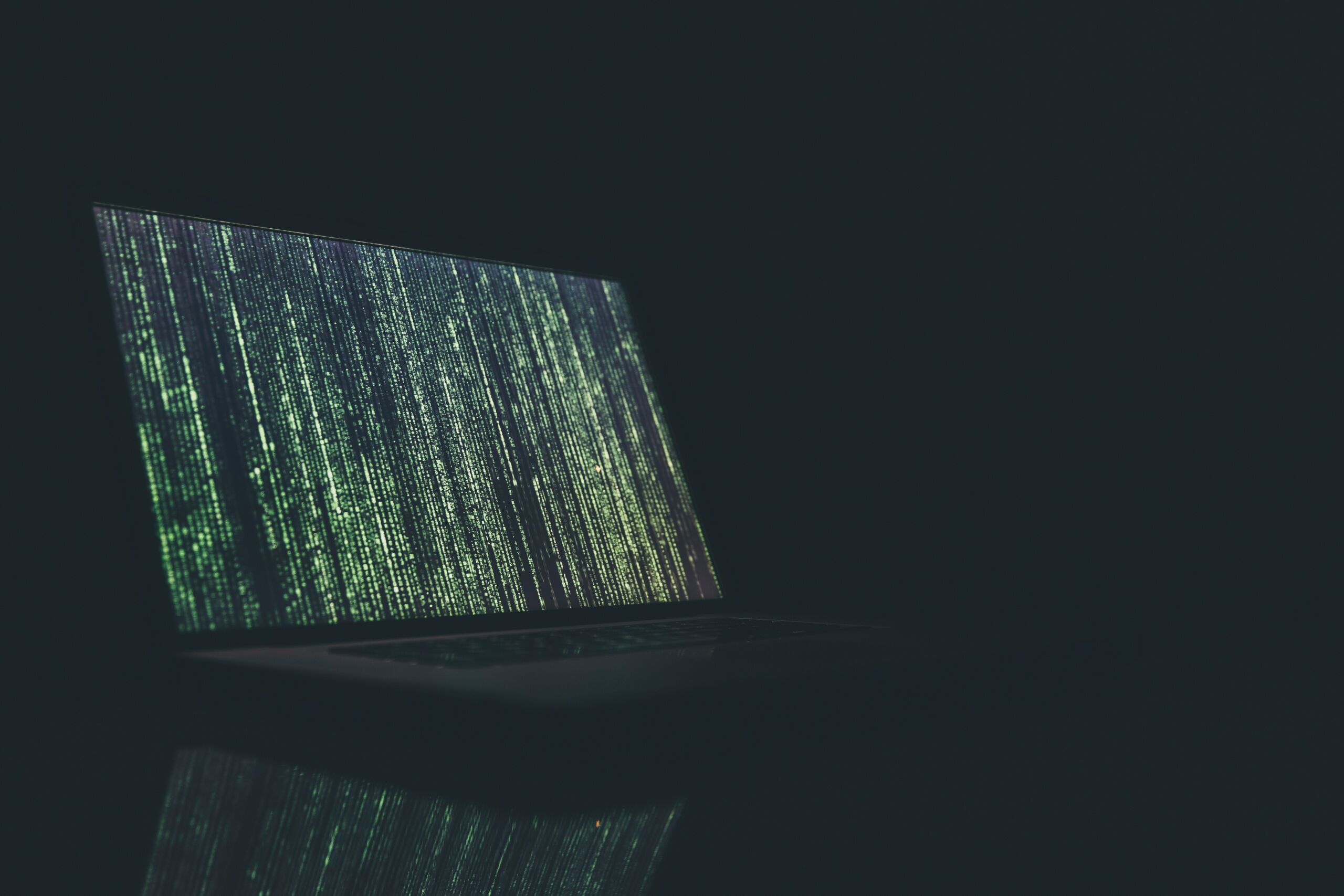 A laptop computer with a green screen on it, demonstrating API Security.