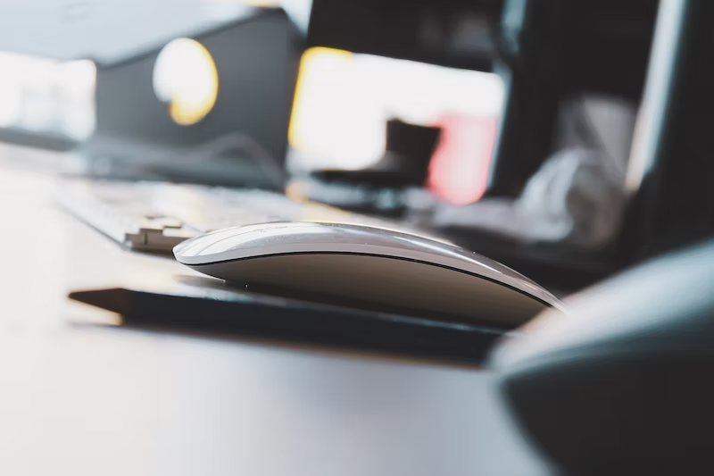A computer mouse sits on a desk.