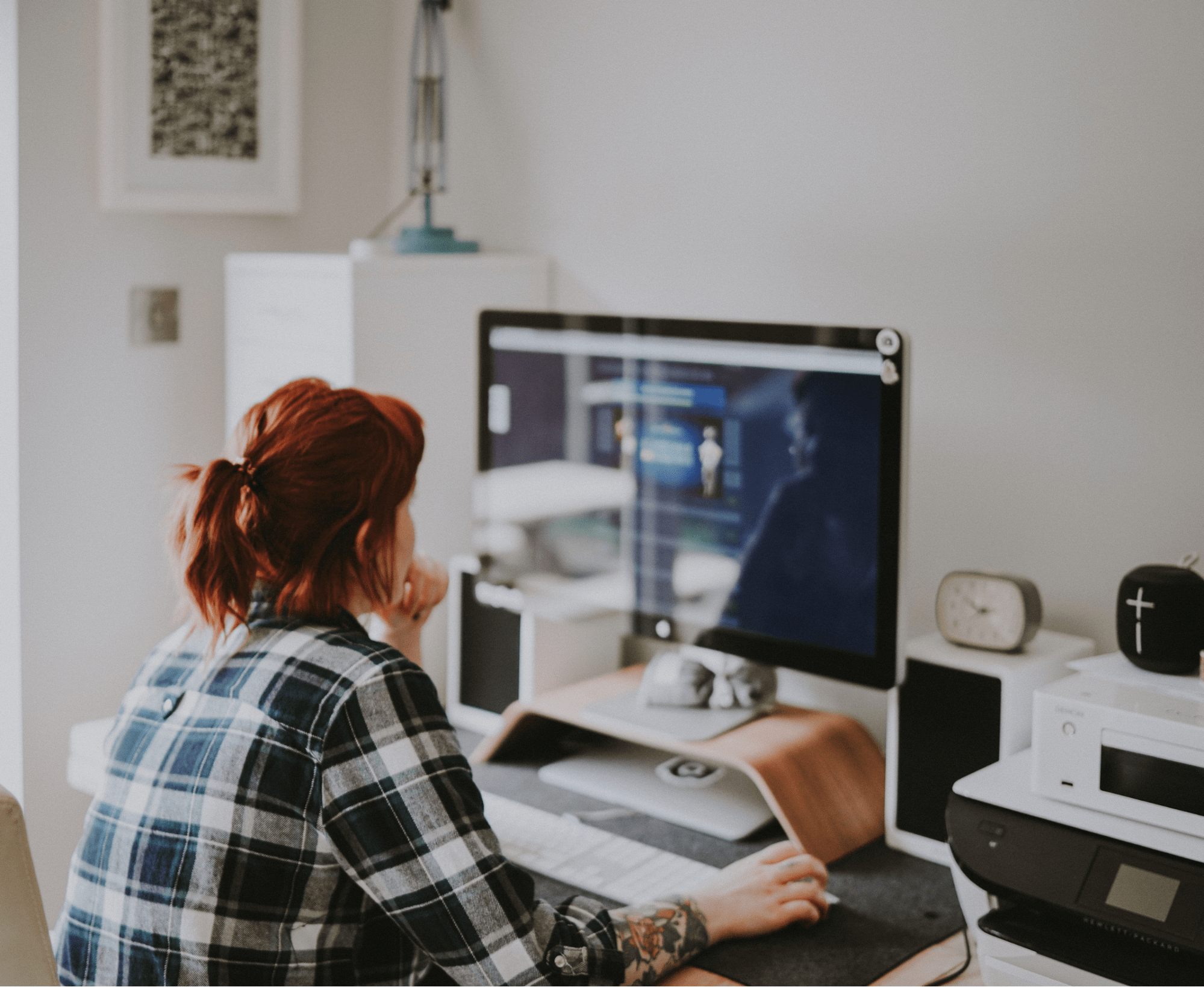 A woman sitting at a desk in front of a computer.