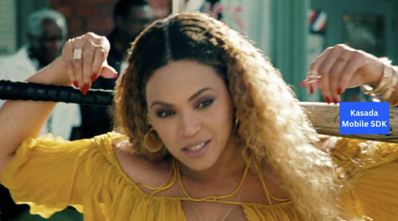 A woman, an engineer in a yellow dress, is holding a baseball bat.