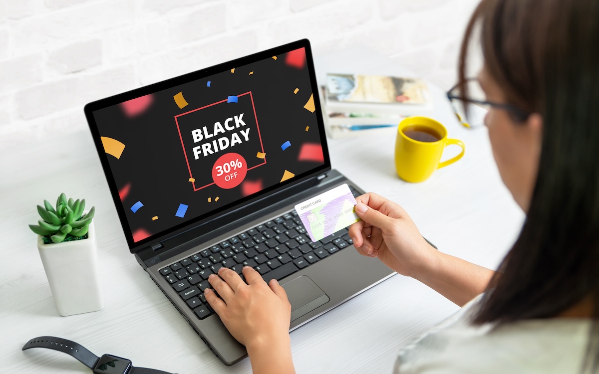 Woman on a laptop looking at 2024 holiday sales for a blog about holiday bots