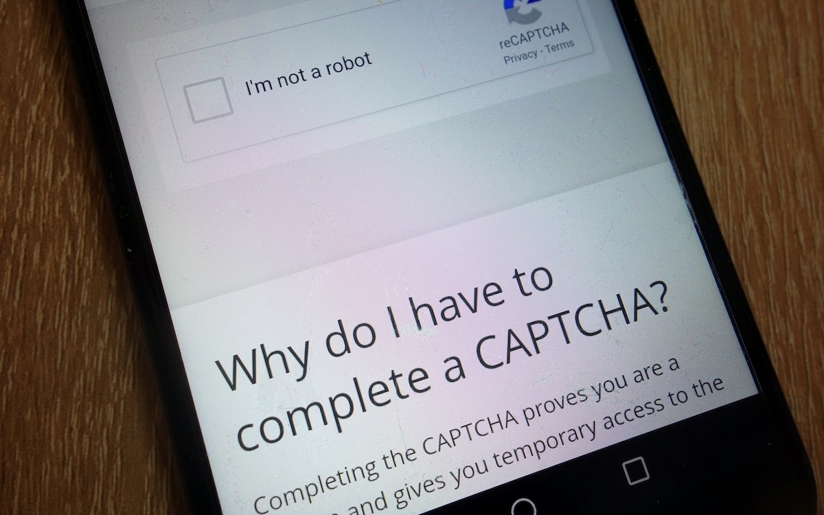 CAPTCHA challenge on a smart phone with text that reads "Why do I have to complete a CAPTCHA?"